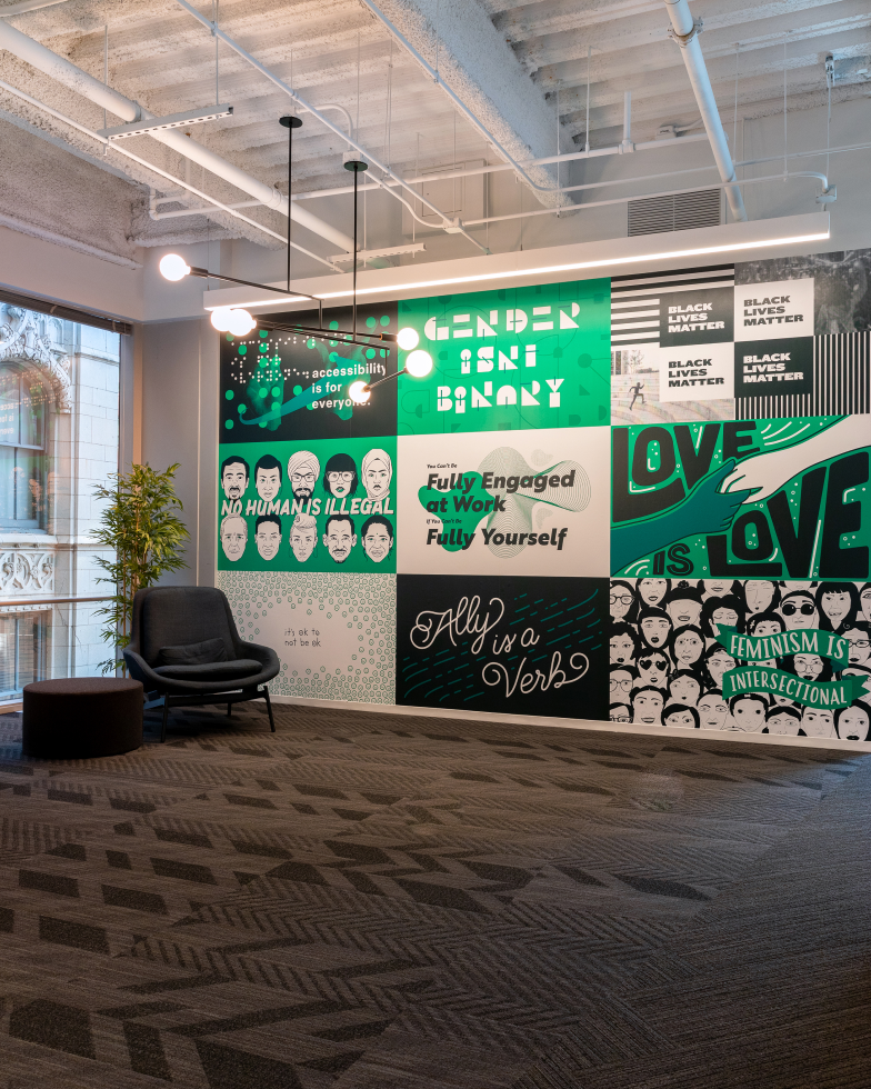 Designed in-house, a DEI mural in the Chicago office features messages like “Love is love” and “ally is a verb.”